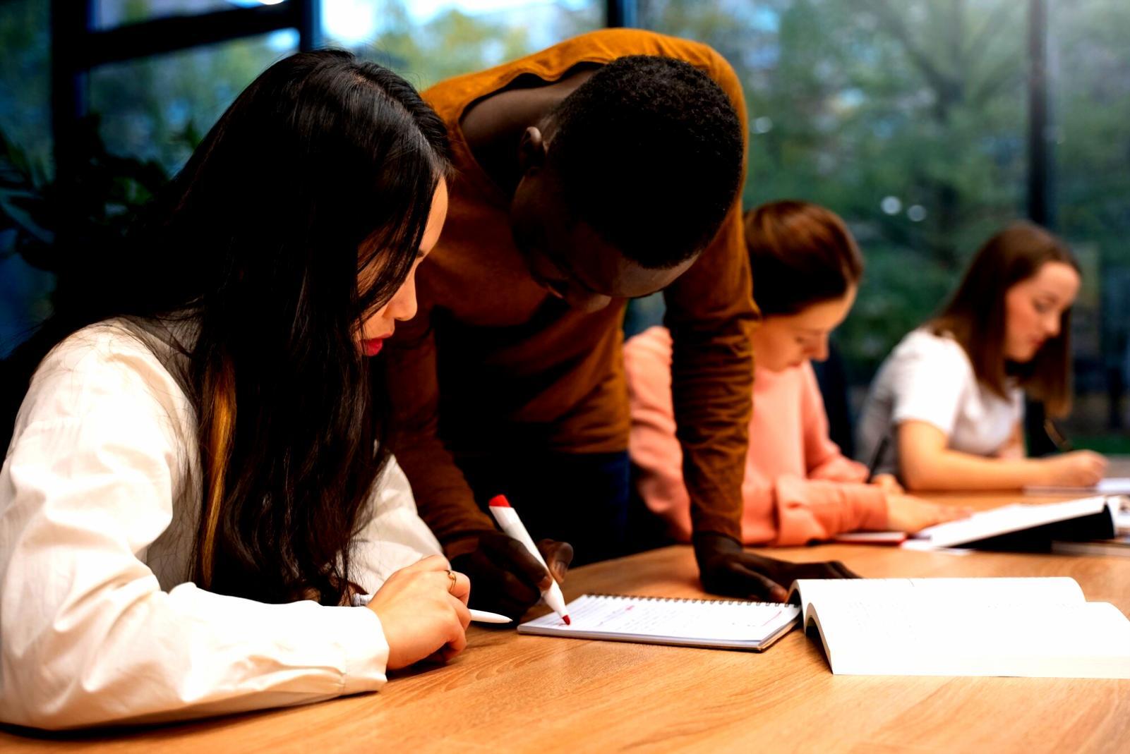 Students working together on financial analysis exercises in classroom setting